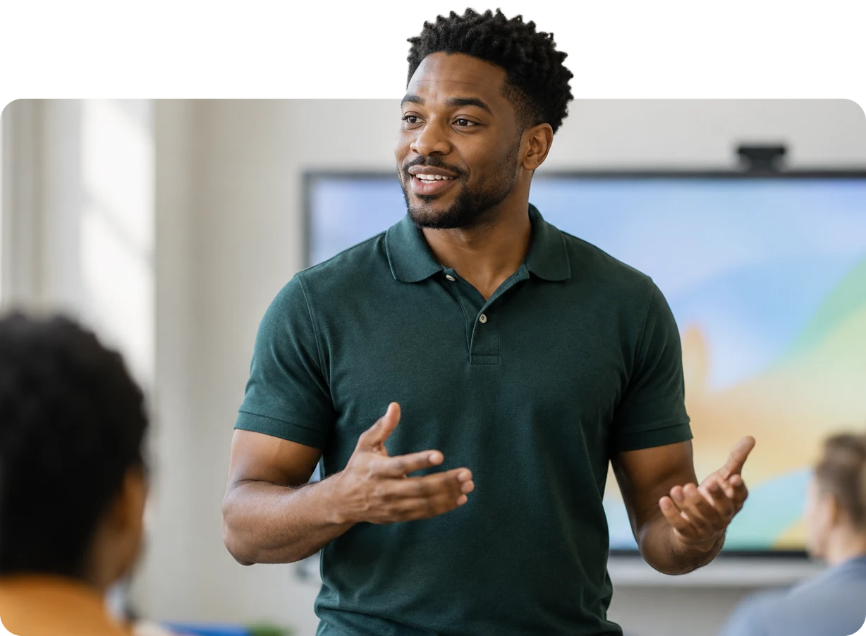 Teacher explaining something to the class in front of the interactive display